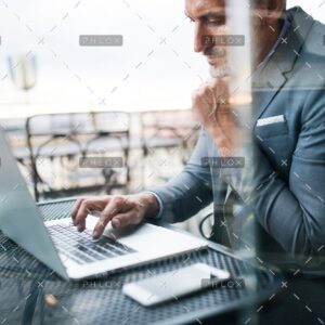 demo-attachment-33-Mature-businessman-with-laptop-outside-a-cafe.